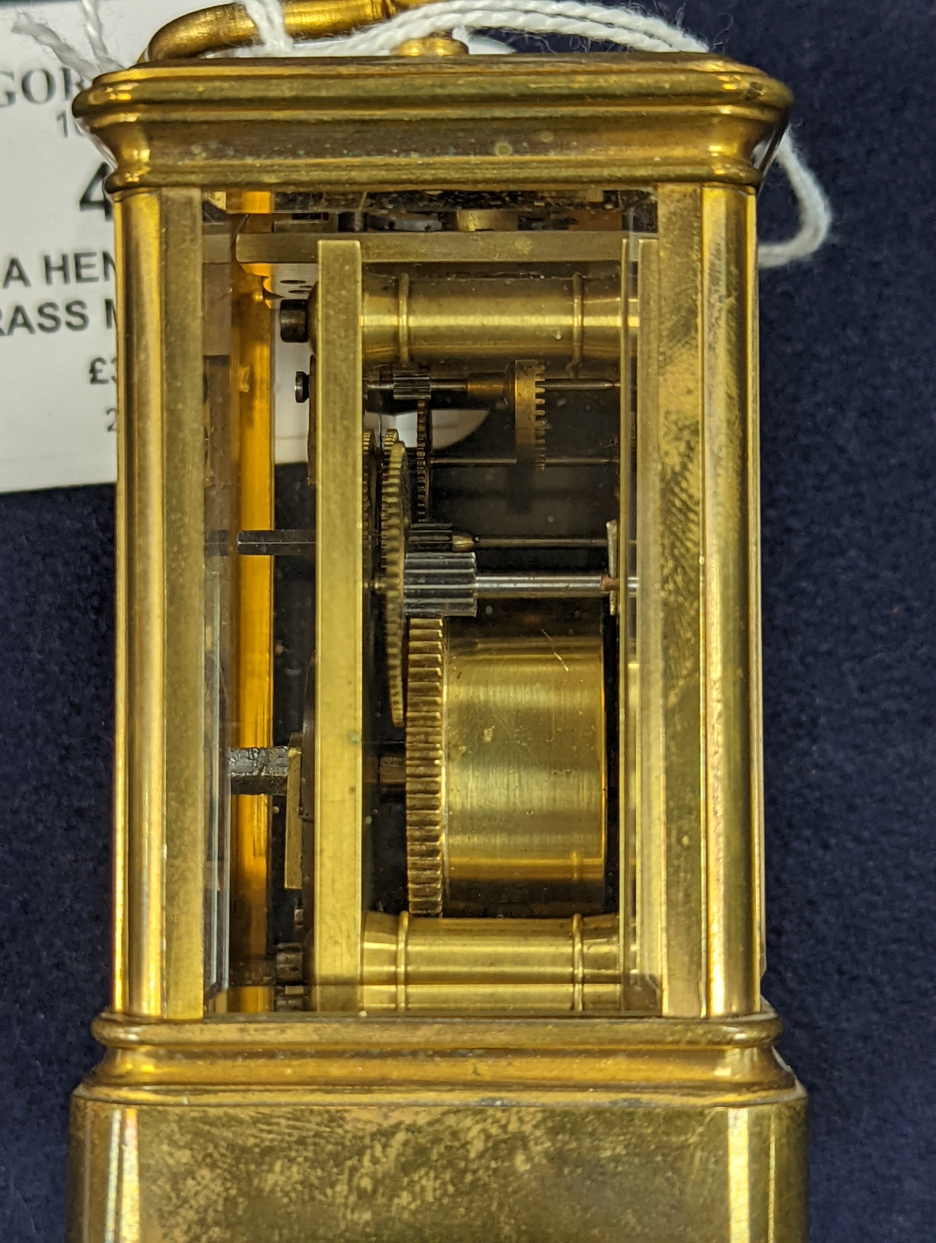 A Henri Jacot brass miniature carriage timepiece, 9.7 cm high with the handle up, cased